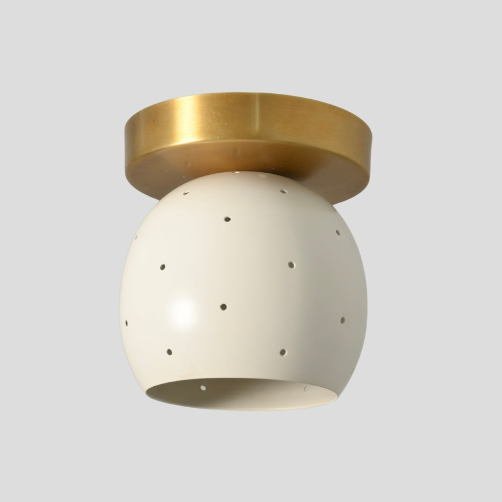 Minimalist mid-century ceiling light in raw brass with matte white dome shade for low ceilings