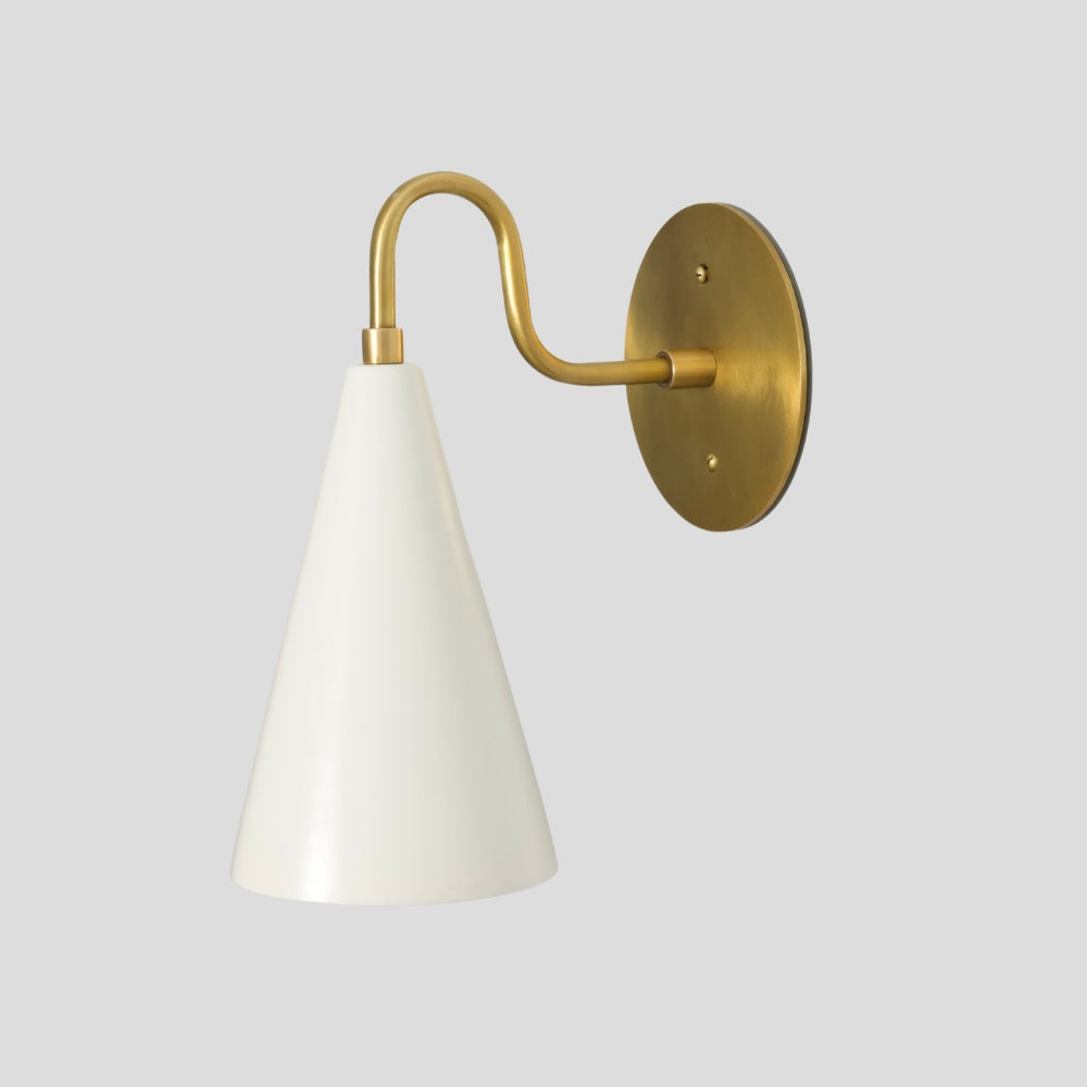 Solid brass cone wall sconce with matte white shade, mid-century inspired accent wall lighting.