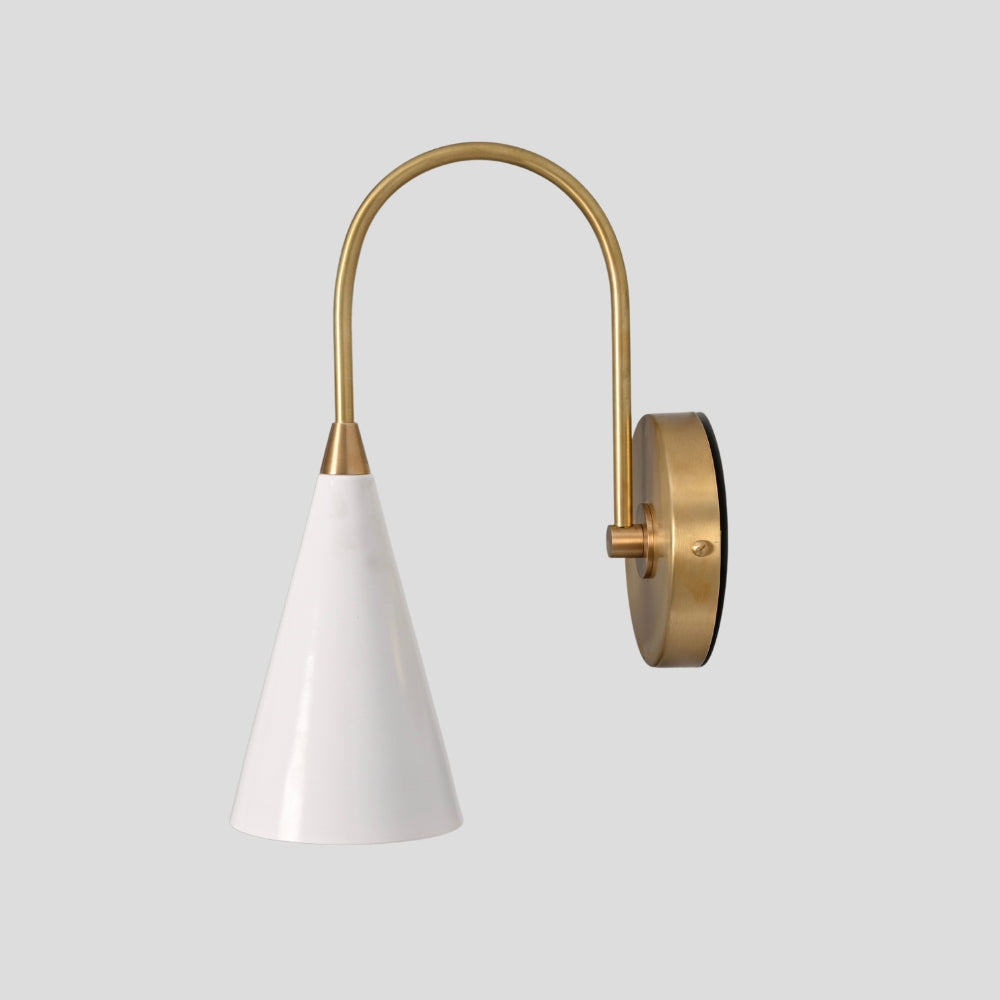 Handcrafted brass sconce with matte white cone shade for hallway or bedside lighting
