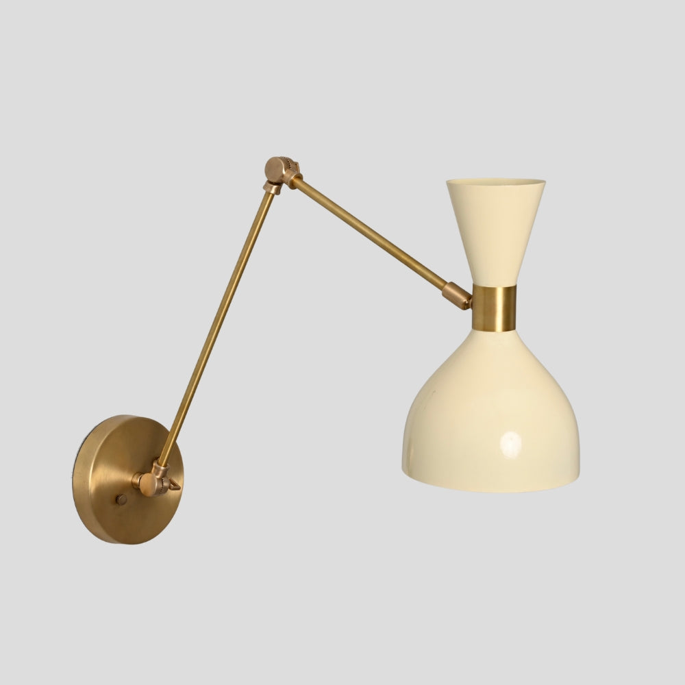 Articulated brass arm wall light with soft cream shade for bedside lighting