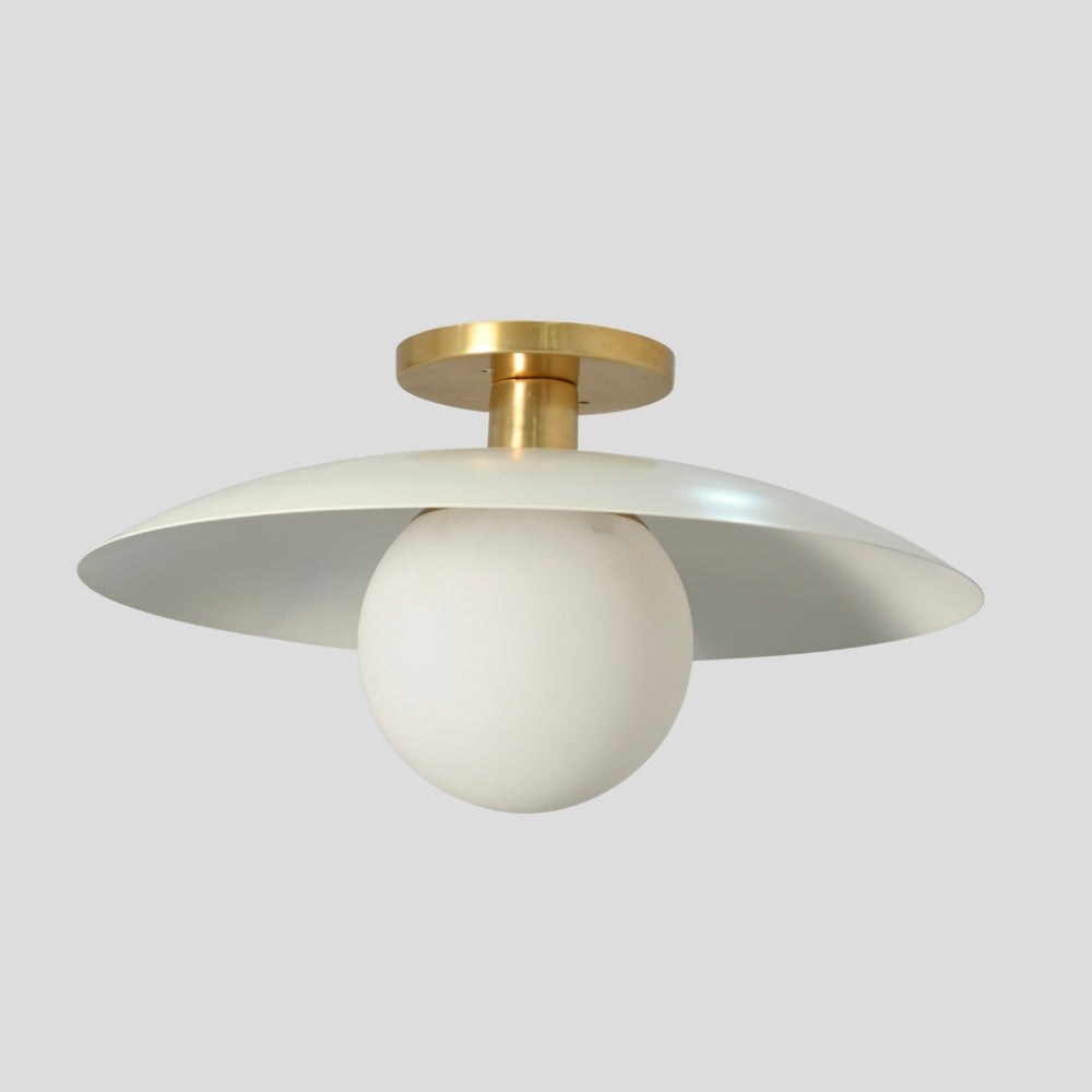 Flush mount ceiling light featuring a smooth, spherical glass globe with a matte white finish, designed for a clean and minimalist look.