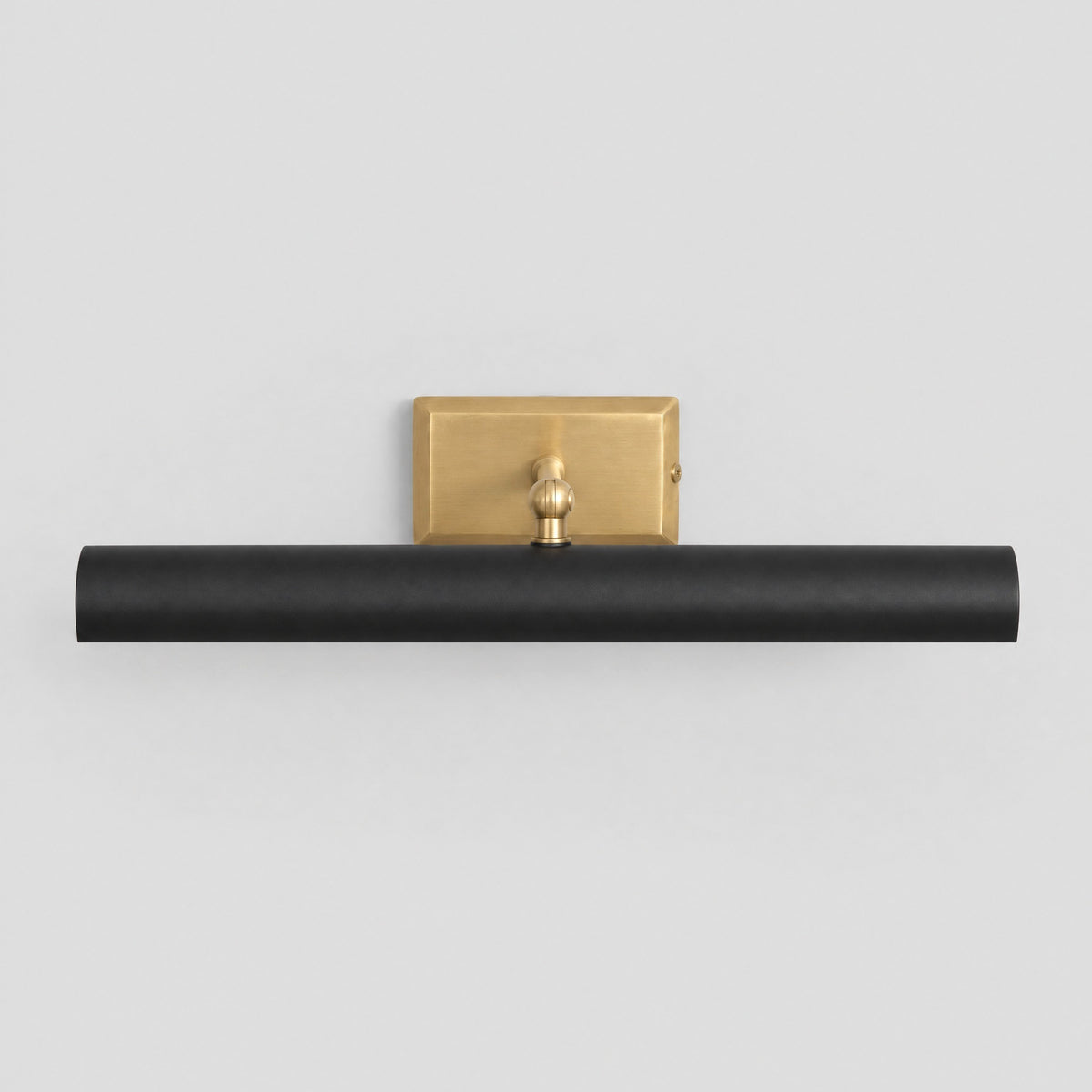 Picture light with matt black shade and solid brass backplate and arm, front view, by BrassBeam
