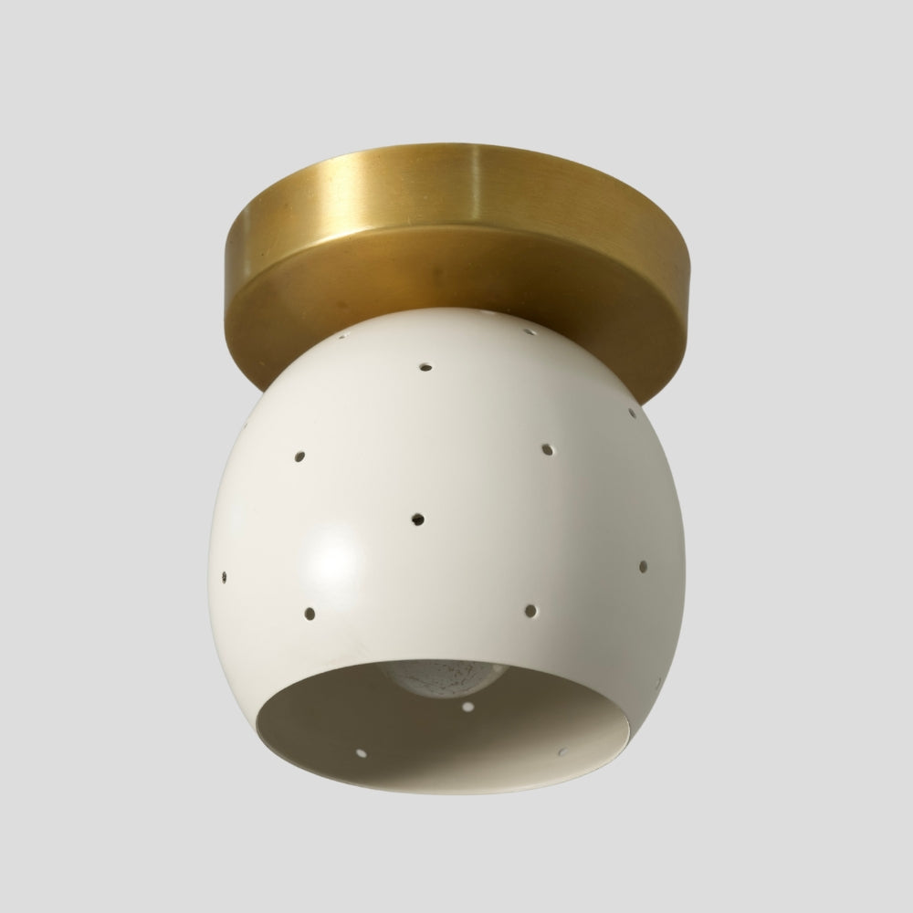 Perforated white dome ceiling fixture in solid brass, compact mid-century flush mount