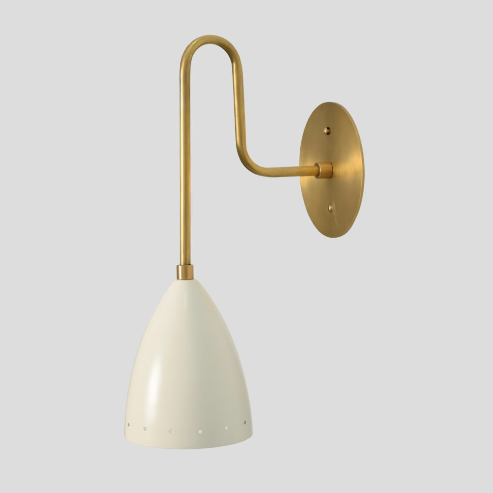 Long arm brass wall sconce with tapered dome white shade on grey background