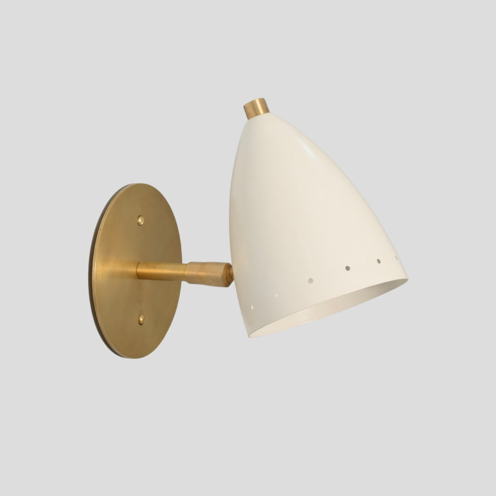 Small brass wall sconce with matte white bullet shade on gray background
