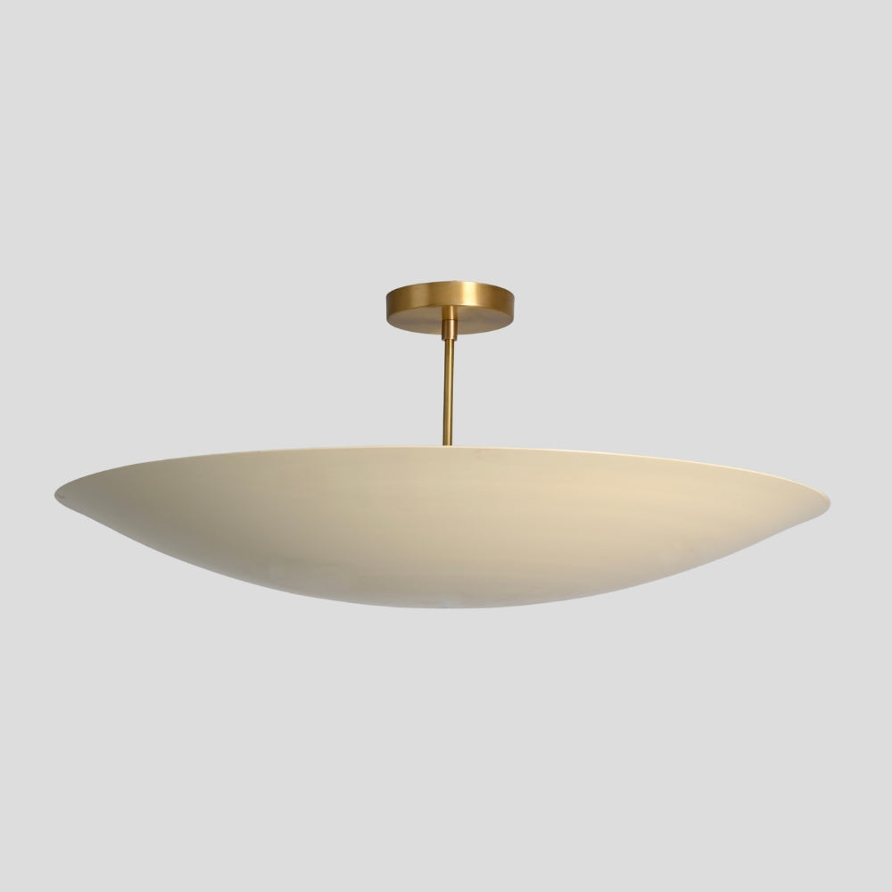 Ceiling light fixture with beige shade and gold finish on a gray background