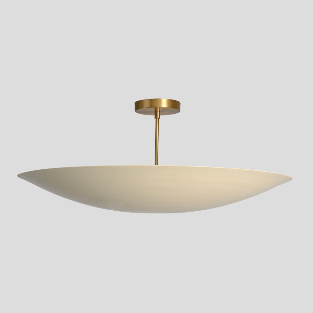Ceiling light fixture with a gold finish and white shade on a gray background