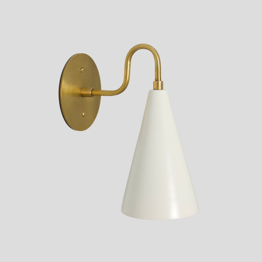 Brass cone wall sconce with matte white perforated shade, modern mid-century wall light.