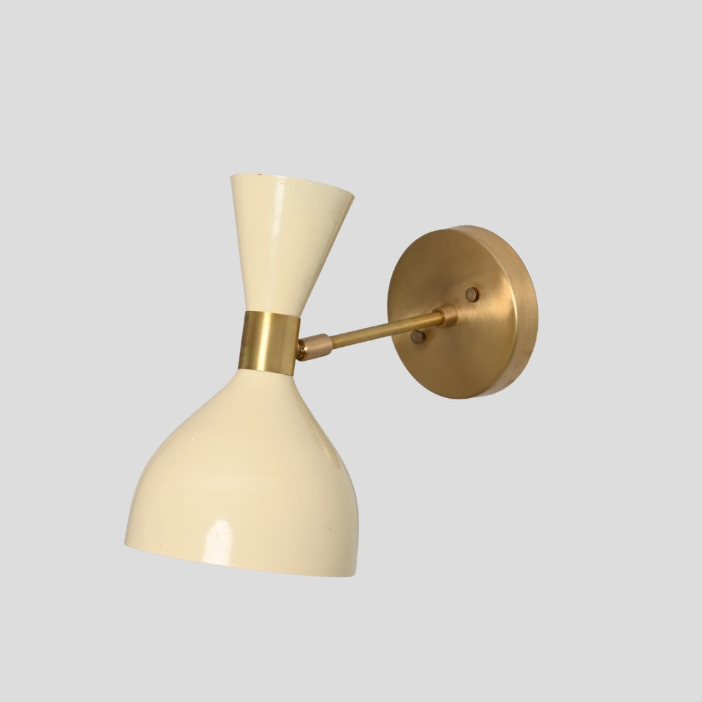 Brass wall sconce with cream hourglass shade on gray background