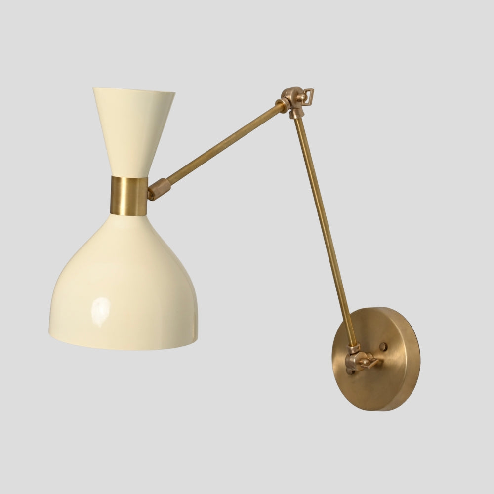 Wall-mounted lamp with cream shade and brass arm on a light gray background
