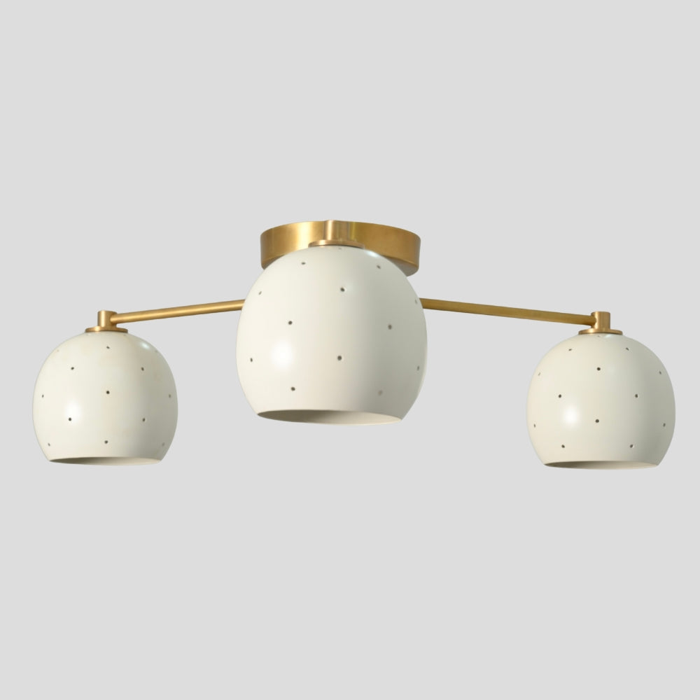 Flush mount ceiling light with three arms, each holding a white spherical shade, creating a balanced, modern design with soft, diffused lighting.