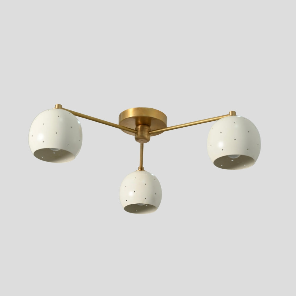 Flush mount ceiling light with three arms, each holding a white spherical shade, creating a balanced, modern design with soft, diffused lighting.