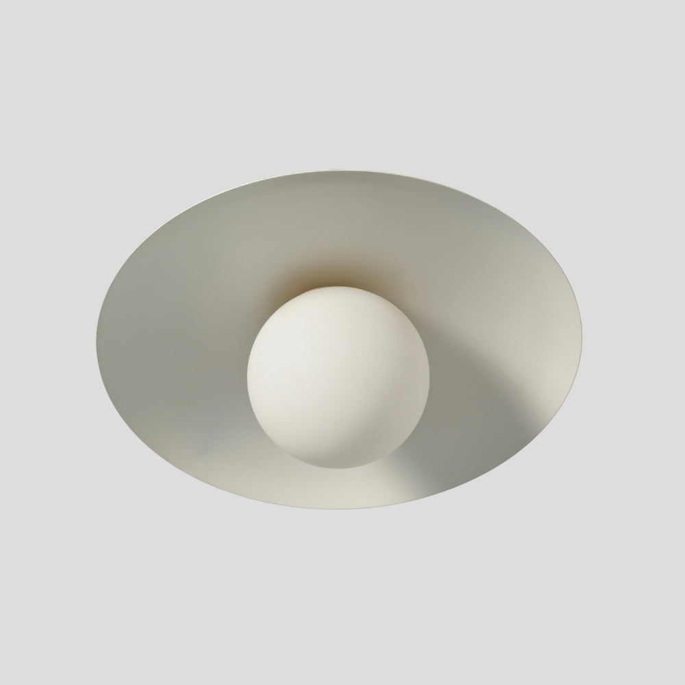 Flush mount ceiling light featuring a smooth, spherical glass globe with a matte white finish, designed for a clean and minimalist look.