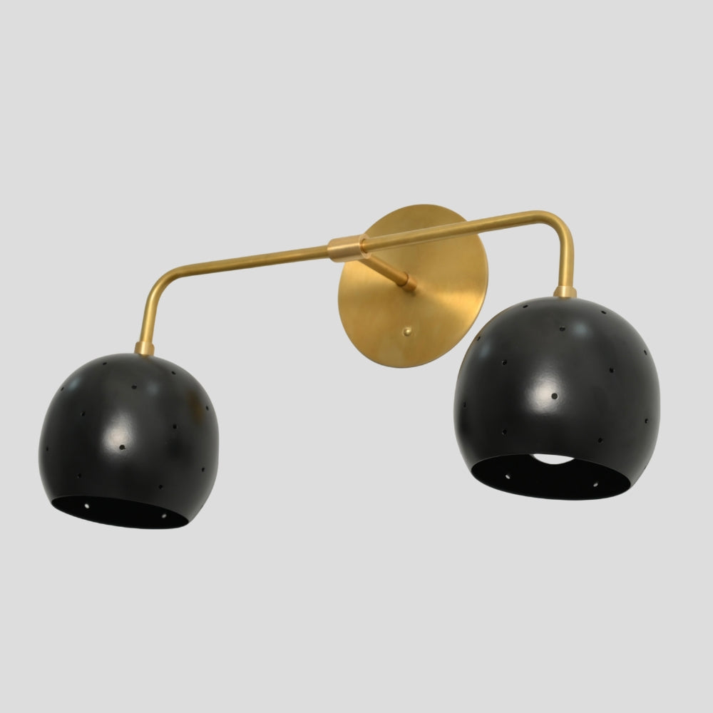 Vanity light fixture featuring a combination of brass and black finishes with spherical ball shades, offering a modern, stylish contrast suitable for bathrooms or dressing areas.