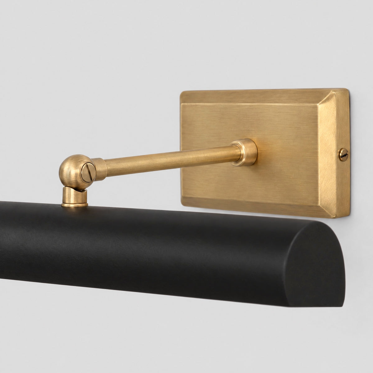 Close-up of the solid brass backplate, arm and swivel joint of the picture light, by BrassBeam